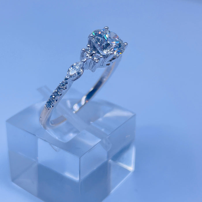 18kt White Gold Engagement Ring. 1.03ct E SI2 center with round and marquise side stones.