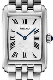 Ladies Seiko watch with white Roman numeral dial, blue hands and a blue cabochon crown.