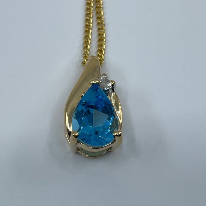 14kt yellow gold pear shaped blue topaz and diamond pendant