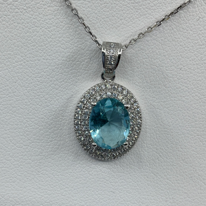 Sterling Silver Oval Simulated Blue Topaz with CZ Border Pendant