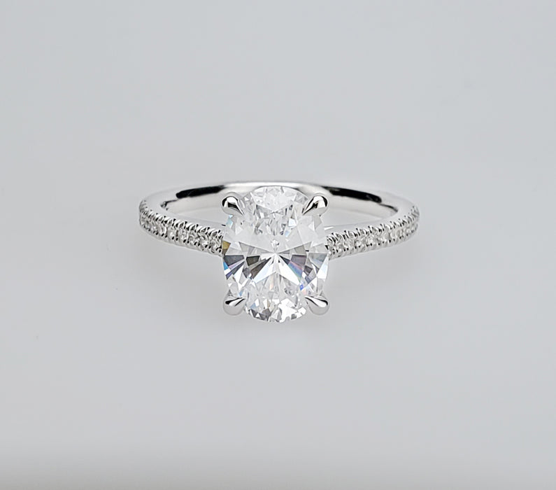 Delicate diamond shank cathedral engagement ring mounting with oval center