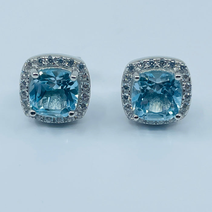 Sterling Silver Blue Topaz Earrings with a CZ halo