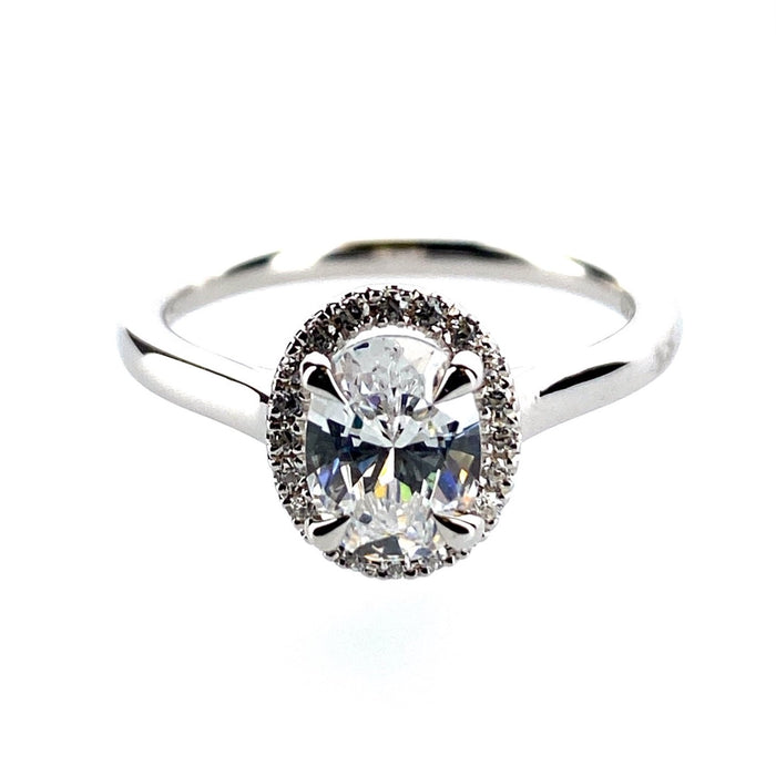 Delicate 20 diamond halo with a plain cathedral shank mounting. .12ctw